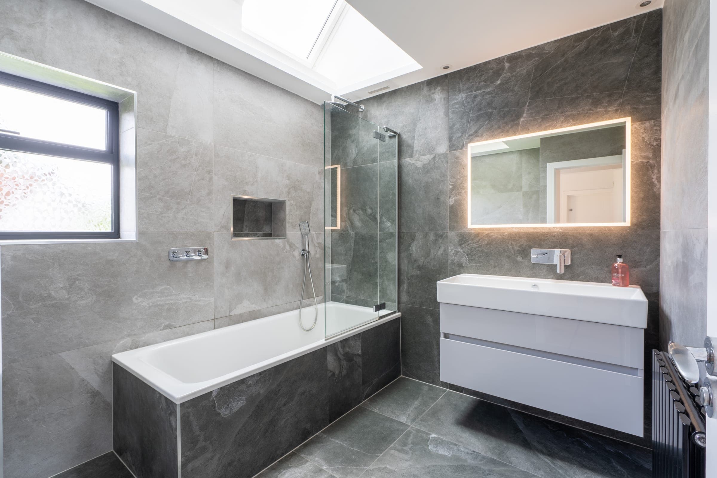 Principal bathroom. Grey marble with backlit mirror