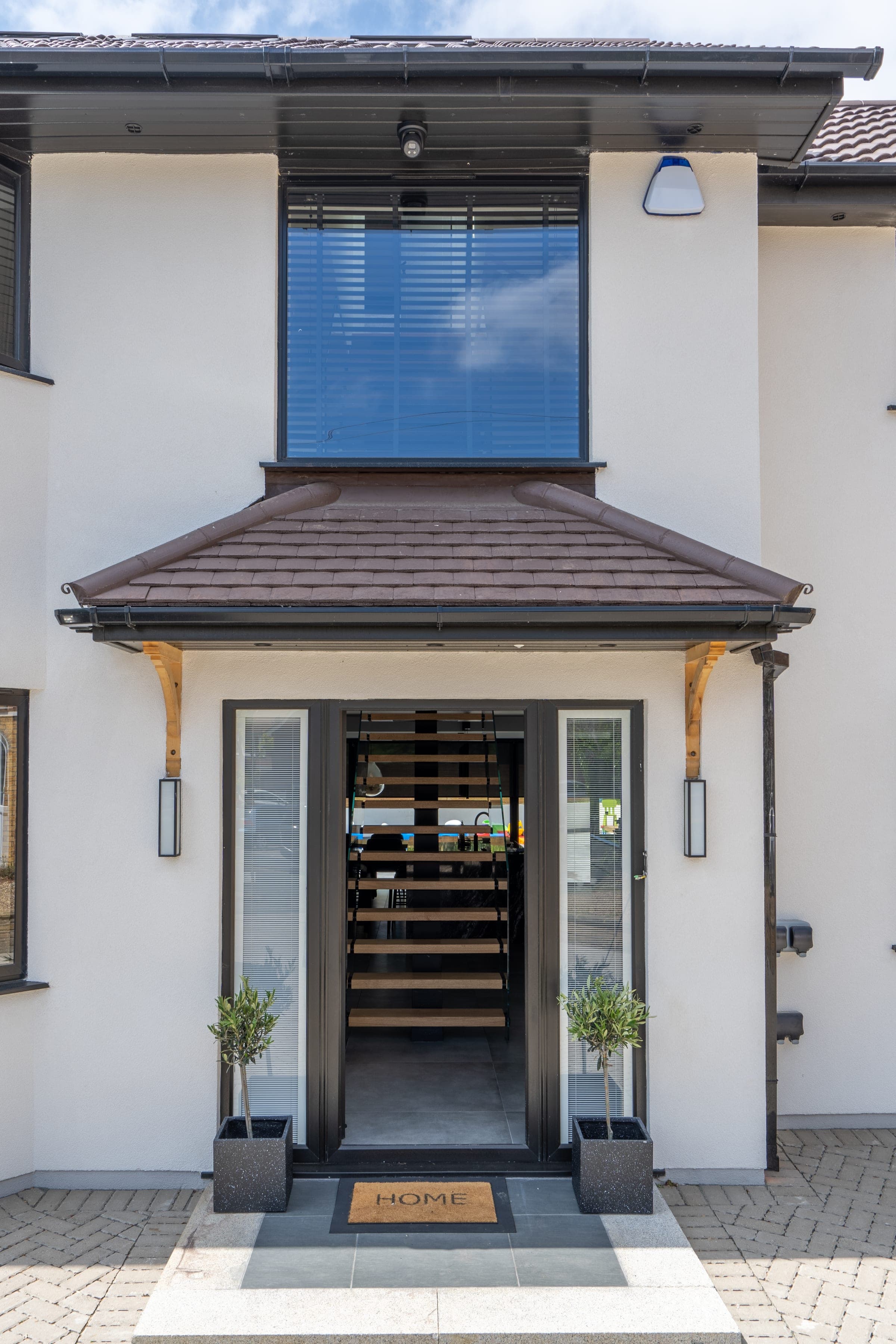 Tiled porch canopy with olive trees at entry, Chorleywood.