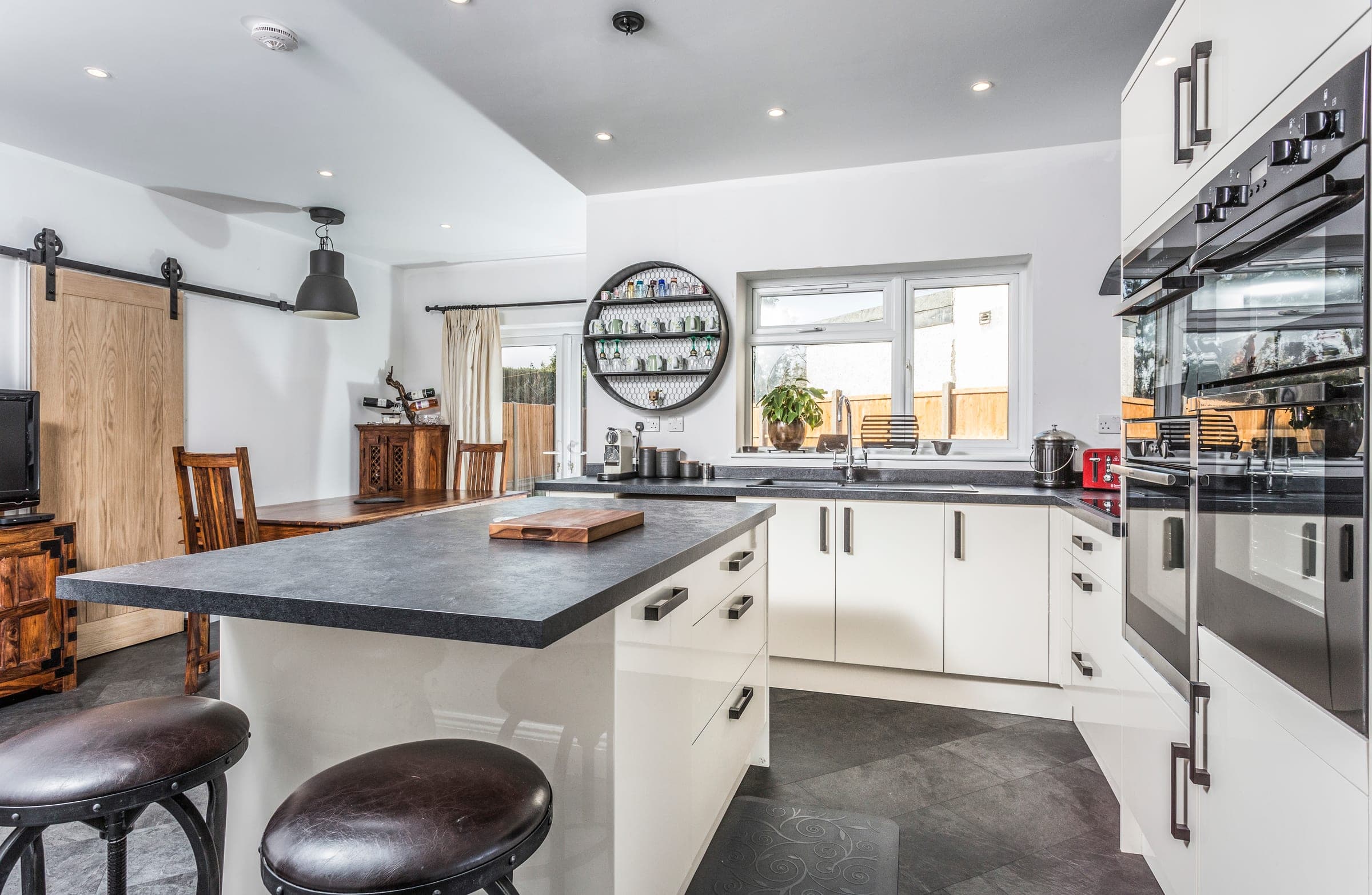 Open-plan kitchen-diner with barn door to snug