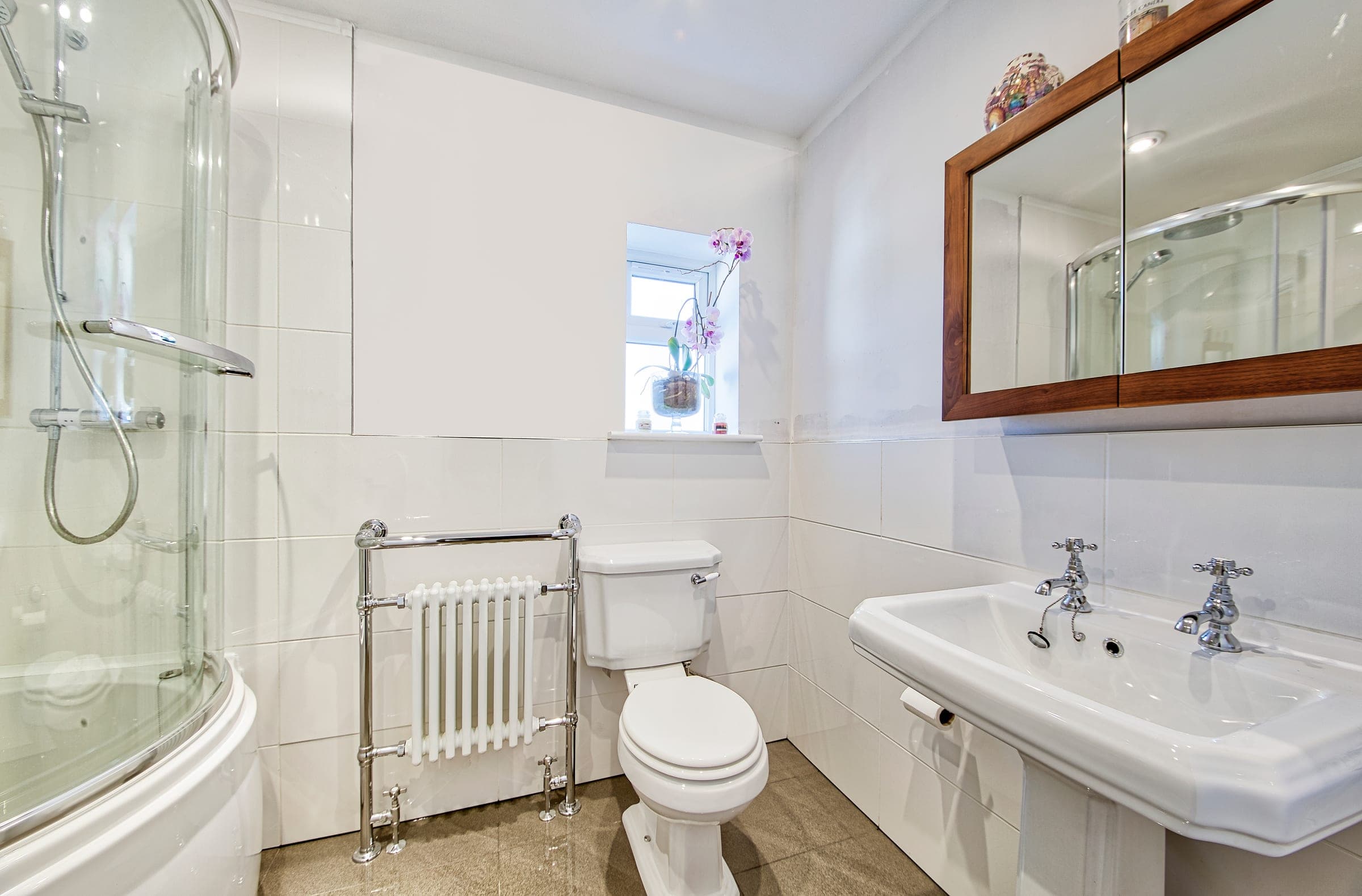 Classic bathroom with pedestal basin, column radiator and cross-head taps, Rayners Lane.