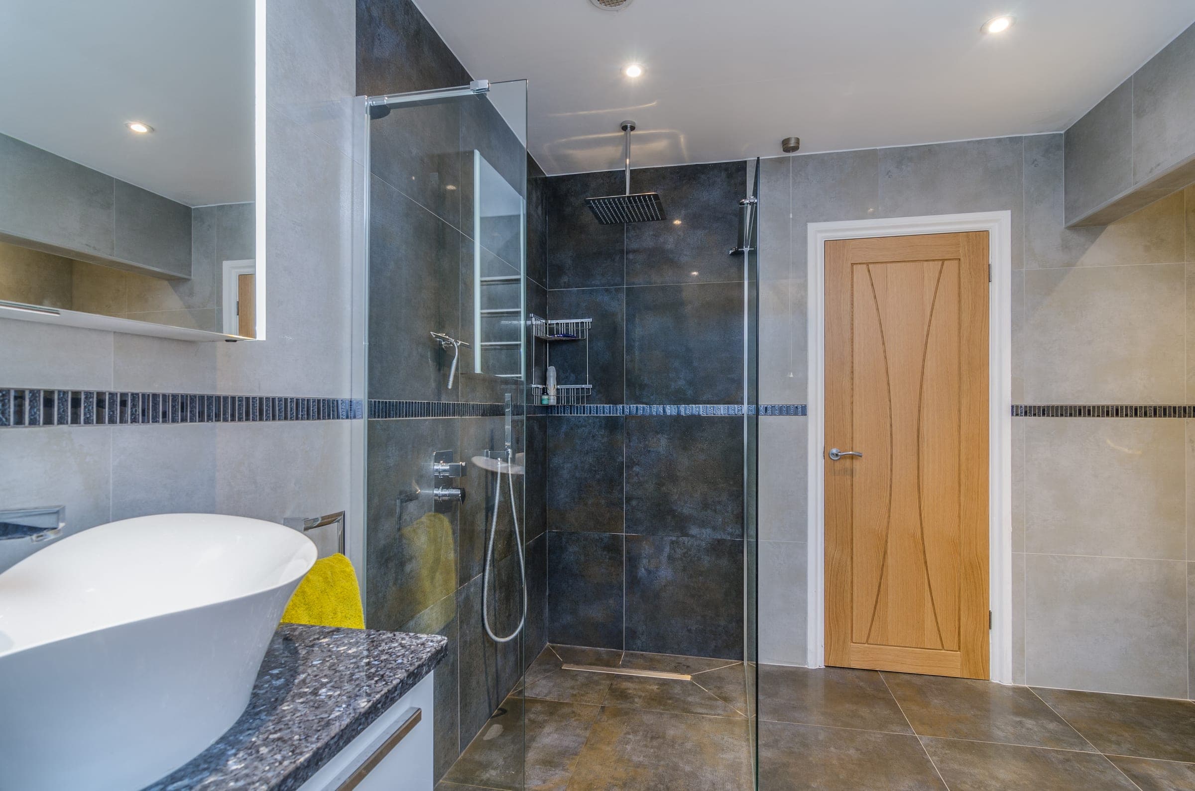 En-suite with walk-in shower, stone vessel basin and oak door, Vicarage Way.